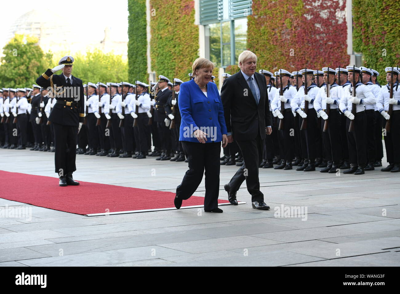 Prime Minister Boris Johnson walks with German Chancellor Angela Merkel in Berlin as he arrives ahead of talks to try to break the Brexit deadlock. Stock Photo