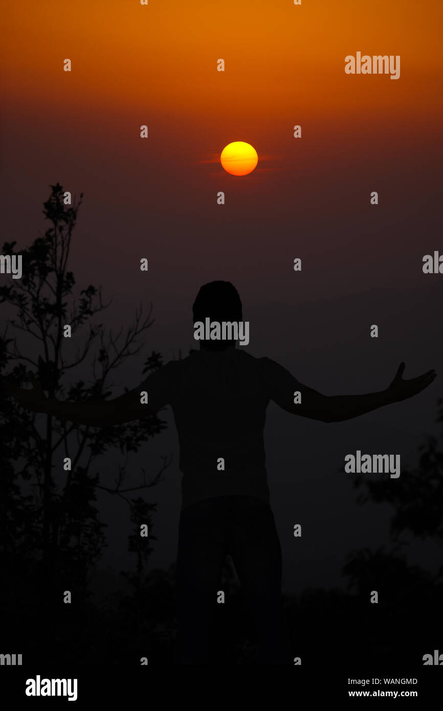 Silhouette of a man with his arms outstretched Stock Photo - Alamy