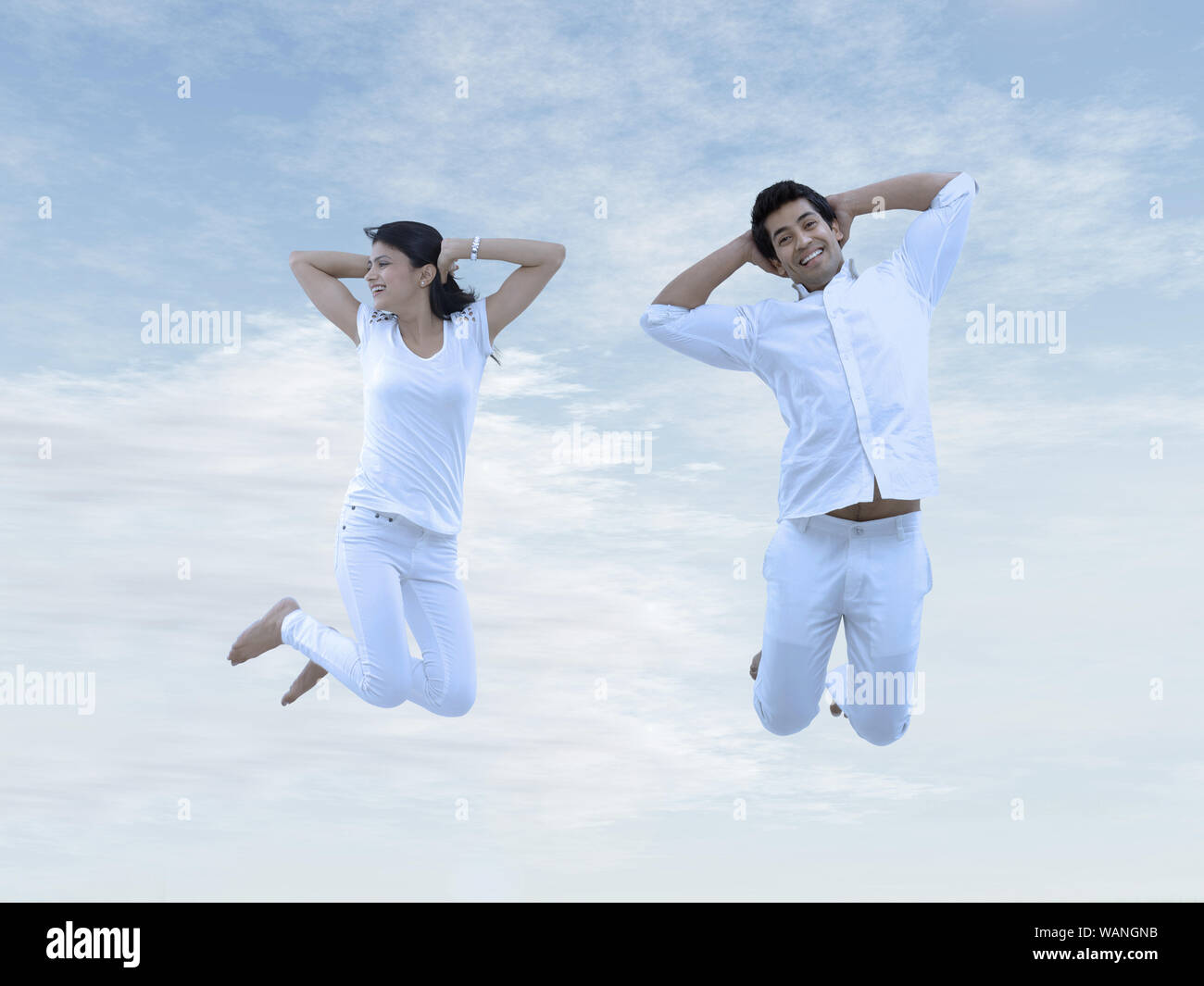 Young couple jumping in air Stock Photo