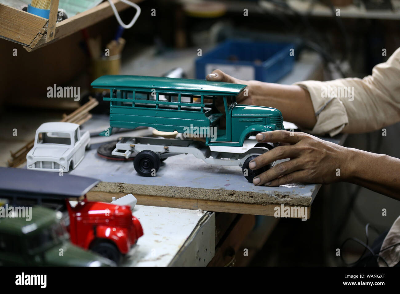 (190821) -- YANGON, Aug. 21, 2019 (Xinhua) -- Craftsman Zay Yar assembles a model car at his workroom in Yangon, Myanmar, Aug. 20, 2019. Zay Yar is a craftsman who has been making wooden miniatures of vehicles dated back to bygone era in Myanmar's largest city Yangon for three years. Being into old generations' vehicles produced around World War II and were broadly used as public transports in Myanmar, Zay Yar initiated his model making hobby in 2016 after working at a auto body shop for a decade. TO GO WITH:Feature: Myanmar craftsman makes wooden miniatures of vehicles from bygone era (Xinhu Stock Photo