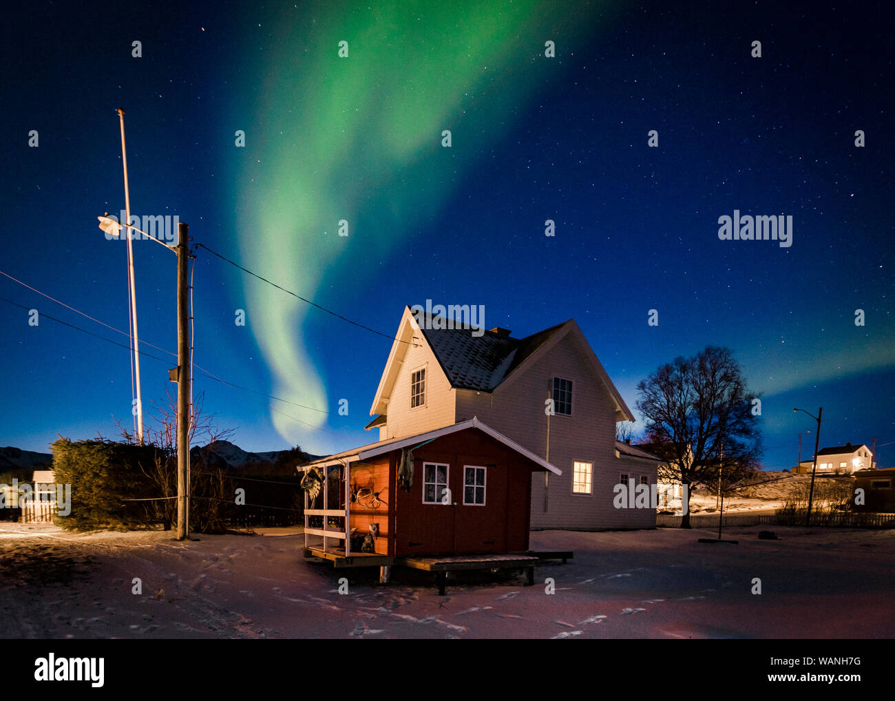 Northern Light Above a Small White House in Stunning Norway Stock Photo