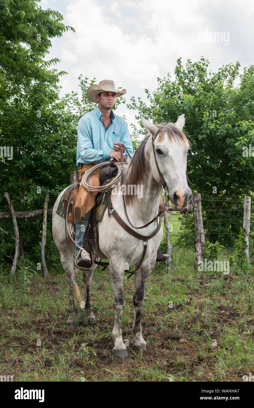 Cowhand Robert Vaughn, atop his horse, Dunnie, at the 1,800-acre Lonesome Pine Ranch, a working cattle ranch that is part of the Texas Ranch Life ranch resort near Chappell Hill in Austin County, Texas Stock Photo