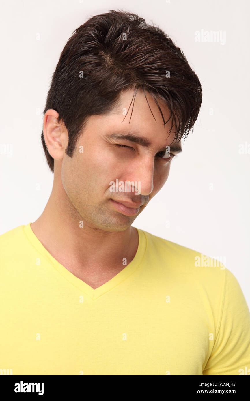 Young man winking towards camera Stock Photo - Alamy