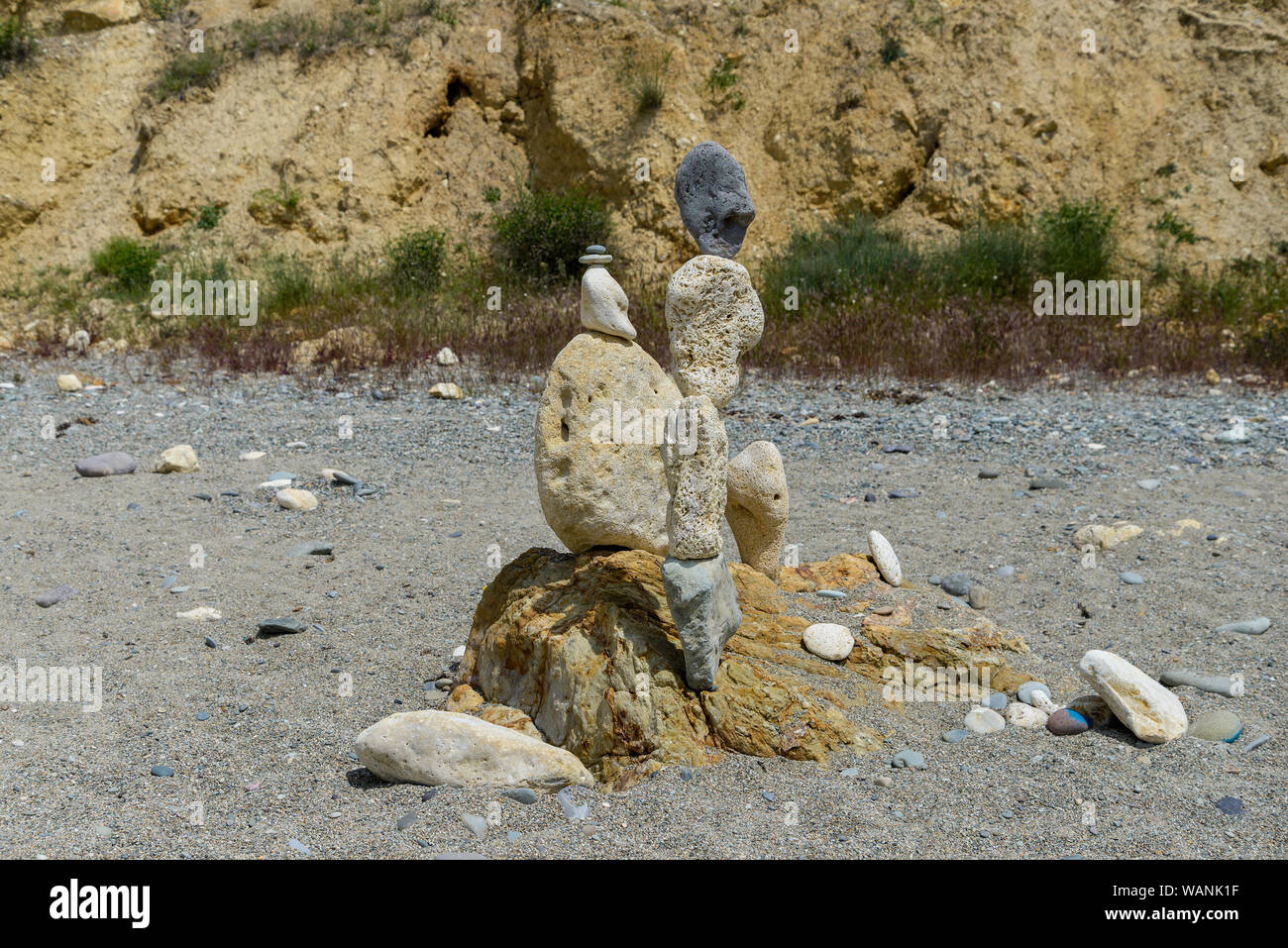A stone sculpture stands on a deserted beach Stock Photo
