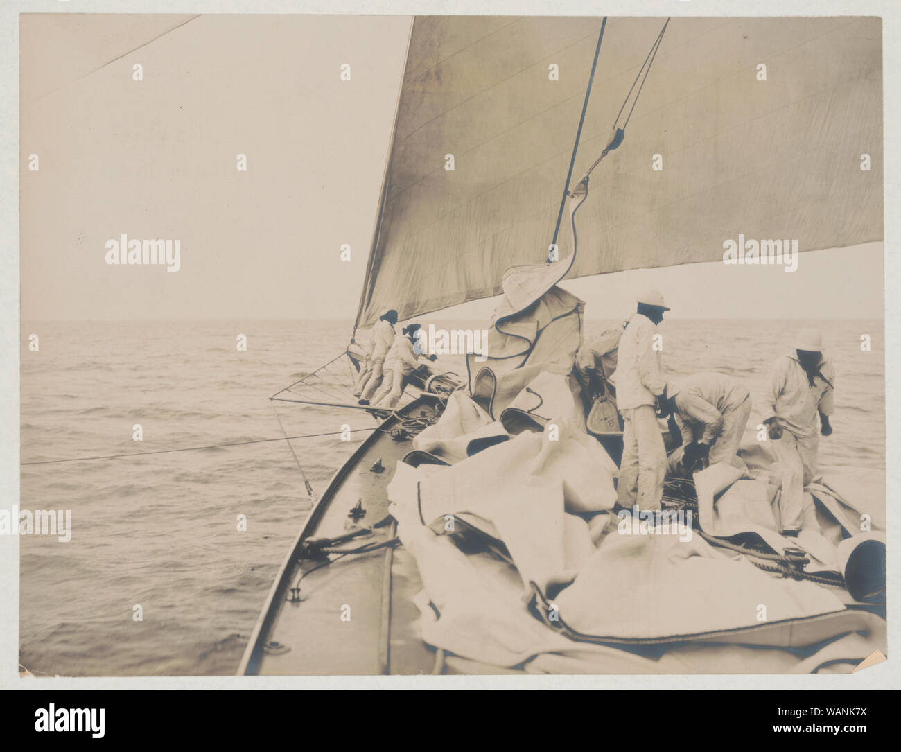 Crew handling sail on the yacht Reliance, winner of 1903 America's Cup Stock Photo