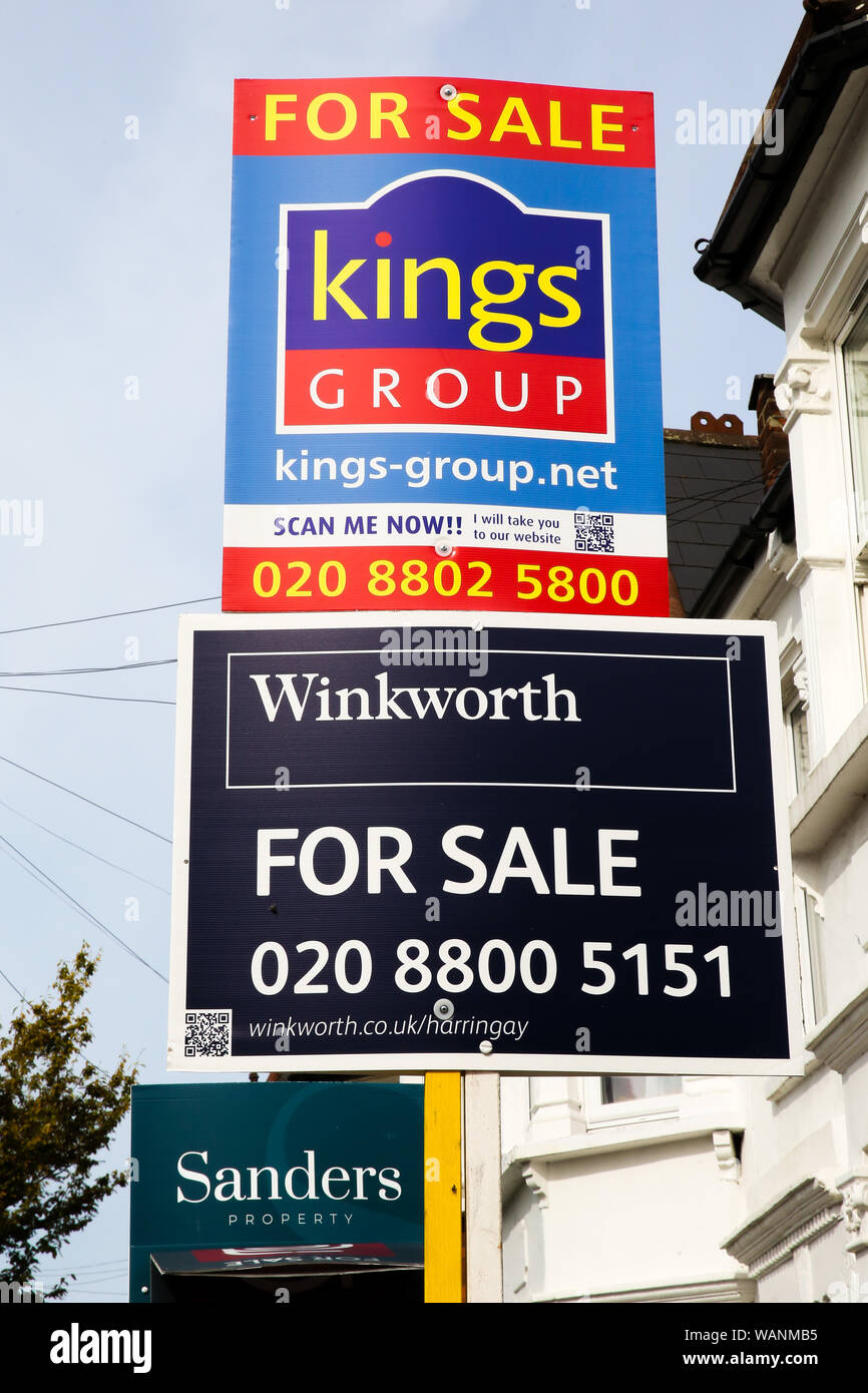 Estate agents property for sale boards on display outside a residential property in north London. The number of house sales increased in August 2019 according to Rightmove, up 6.1% a year earlier. Stock Photo