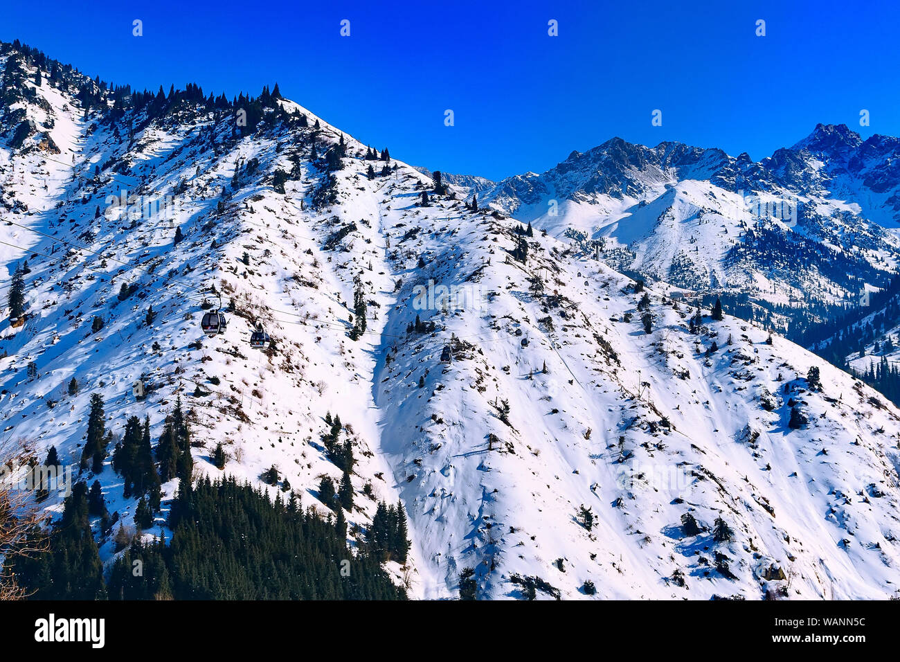 Almaty, Kazakhstan ski lift, cable car cabin at Medeo to Shymbulak route against mountain background Stock Photo