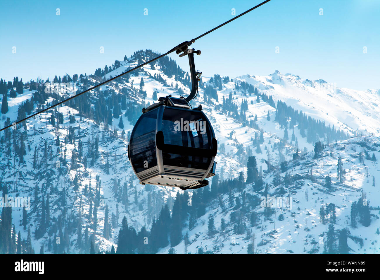 Ski lift, Gondola lift, cable car at Medeo to Shymbulak route near Almaty against mountain background Stock Photo