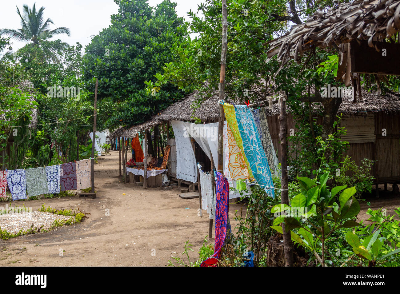 Village with wooden cottages and colorful towels for sale at Lokobe nature strict reserve in Madagascar, Nosy Be, Africa Stock Photo