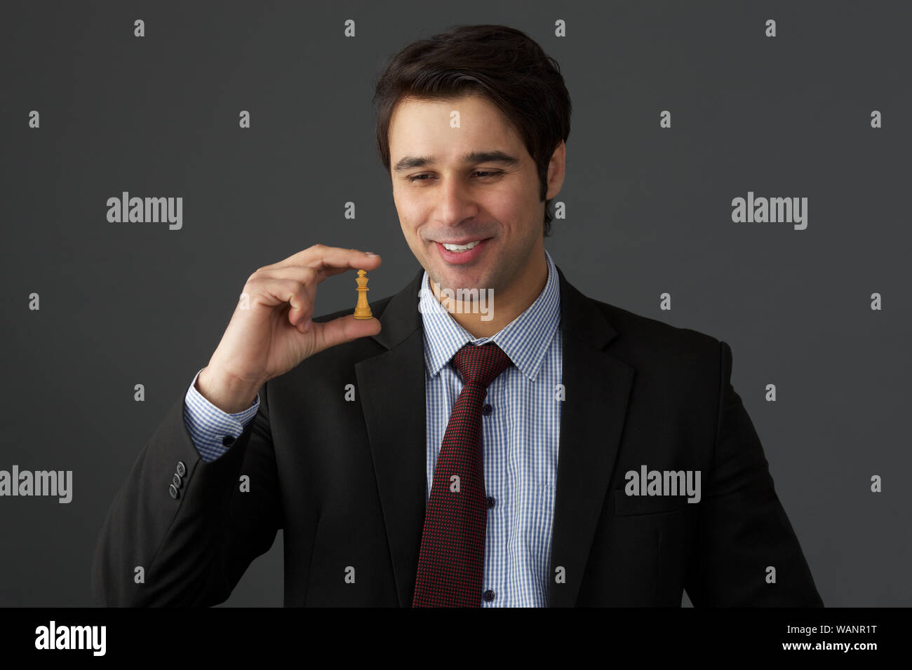 Businessman holding a chess piece of Queen Stock Photo