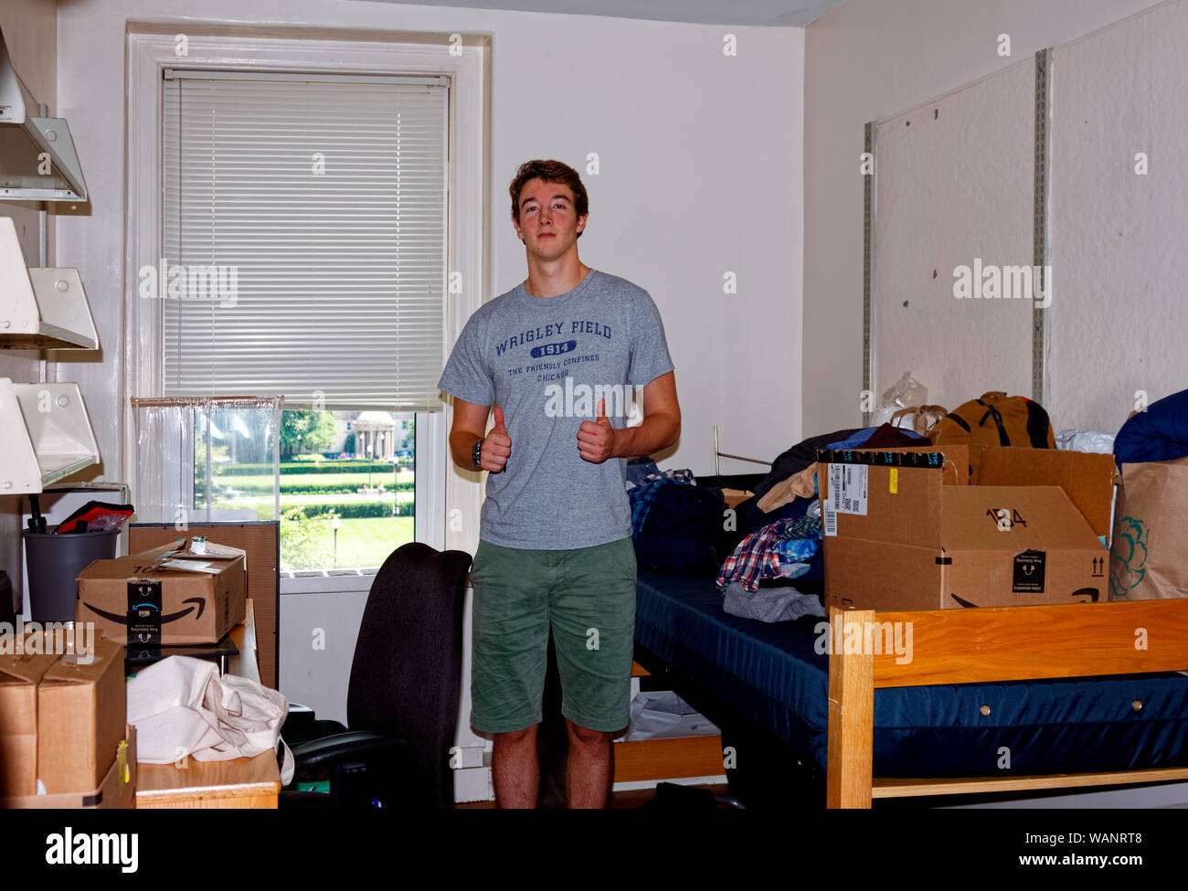 teen boy, college freshman, moving in, single dormitory room, ready to unpack, new experience, challenge, Columbia University, USA, New York, NY, summ Stock Photo