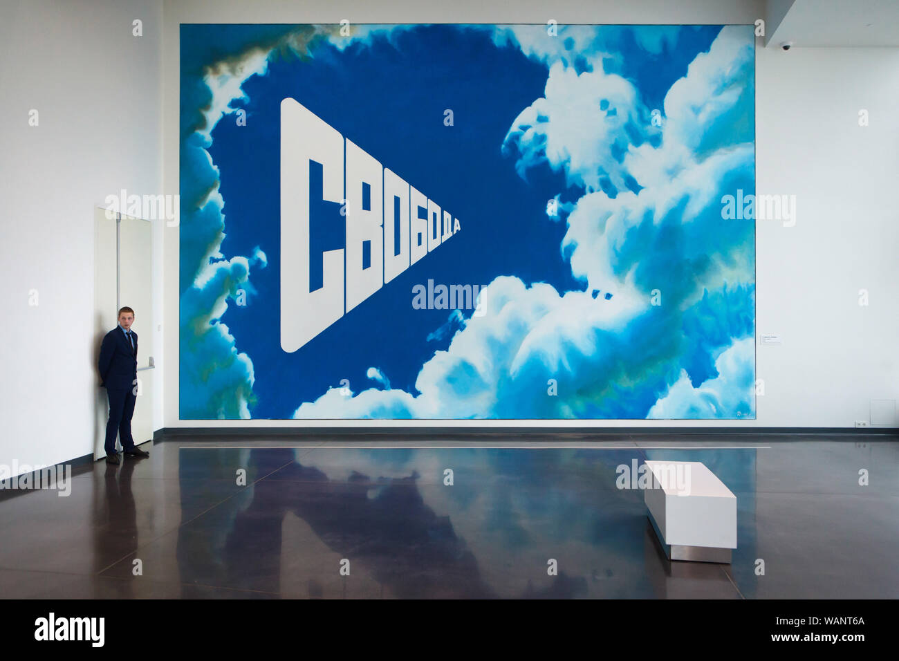 Custodian guards the painting 'Freedom' by Russian conceptual