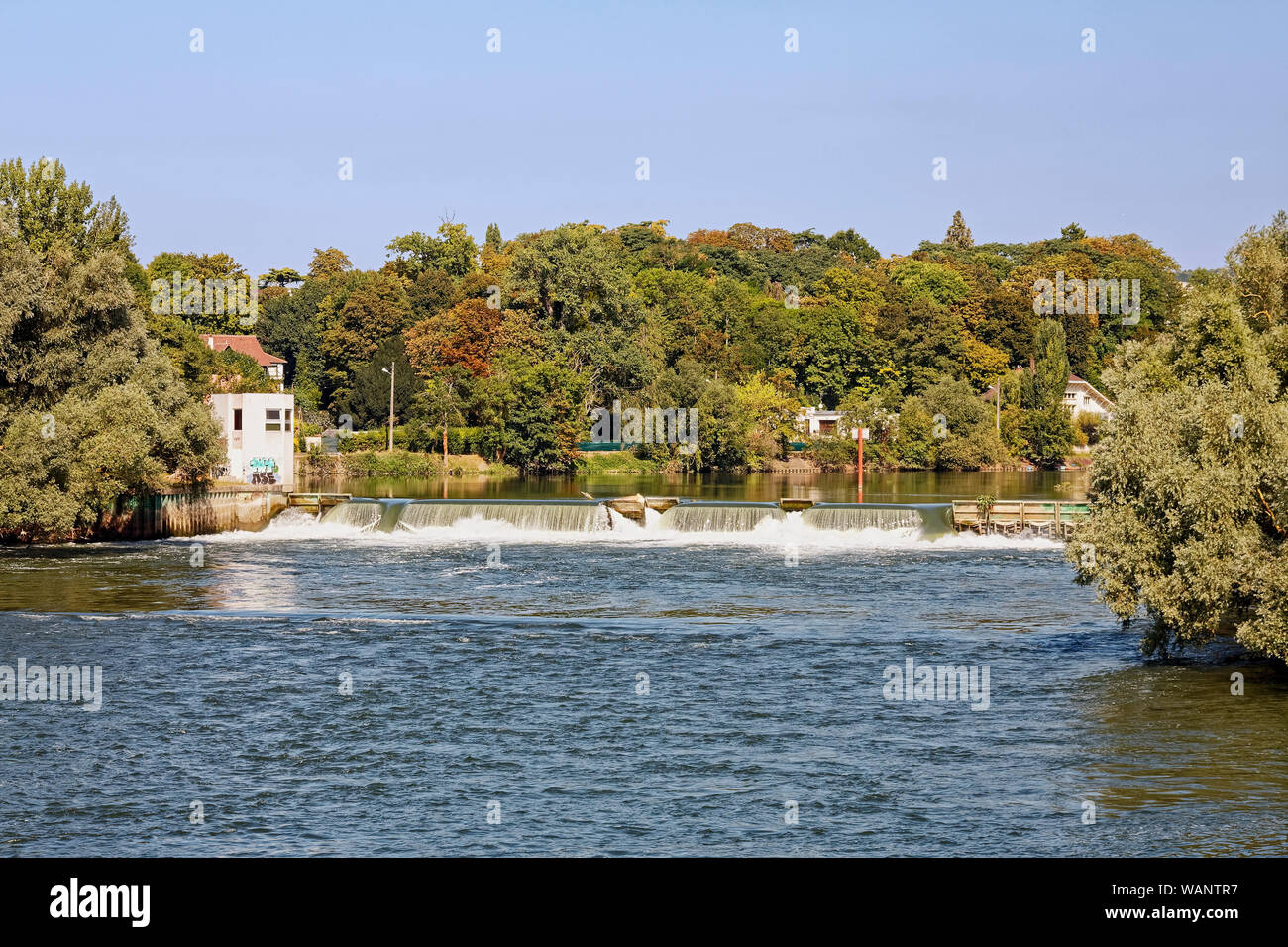 Seine River scene, small dam, water control, houses, trees, Europe; Normandy; France; summer; horizontal Stock Photo