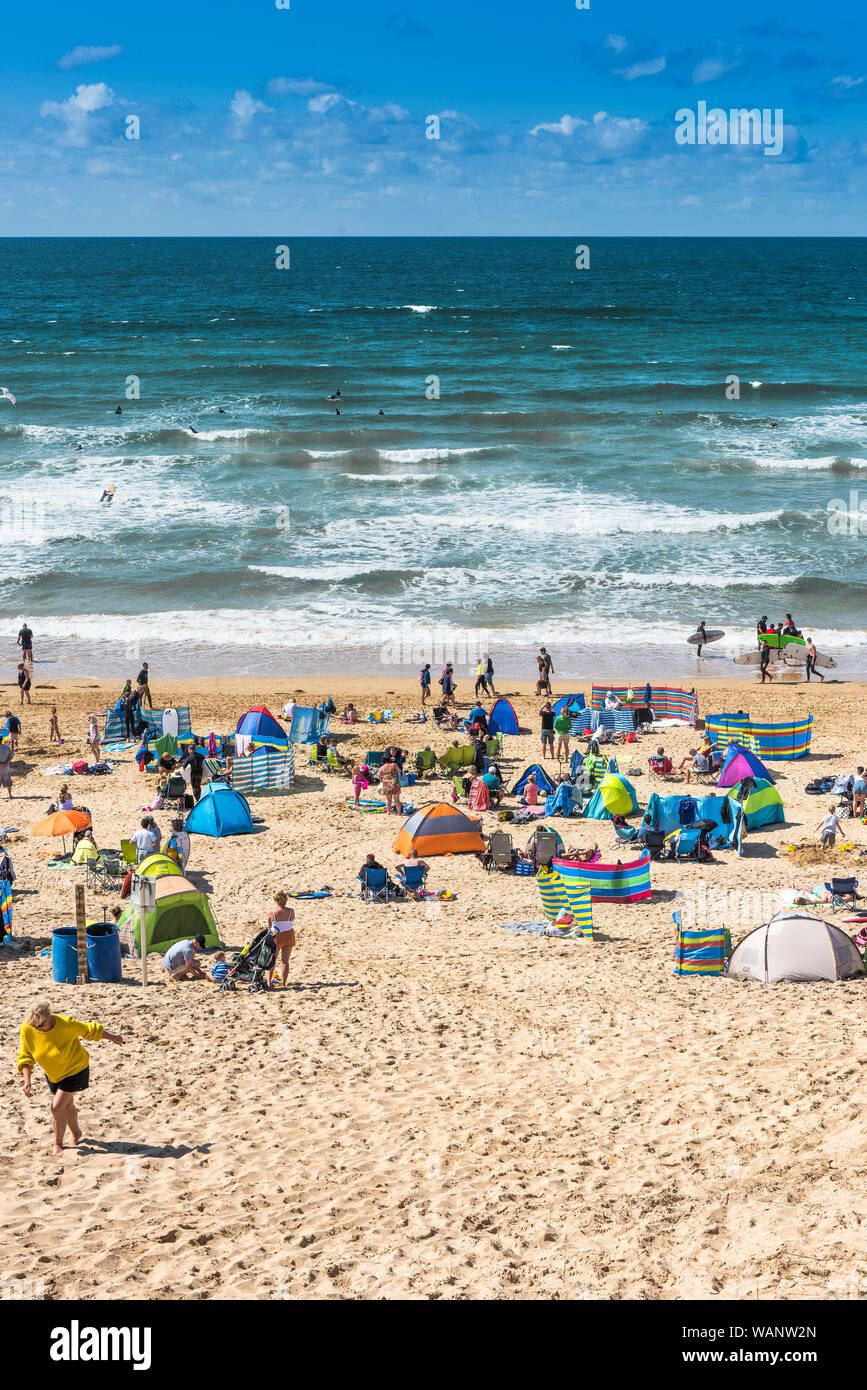 Holidaymakers on a sunny Fistral Beach in Newquay in Cornwall. Stock Photo