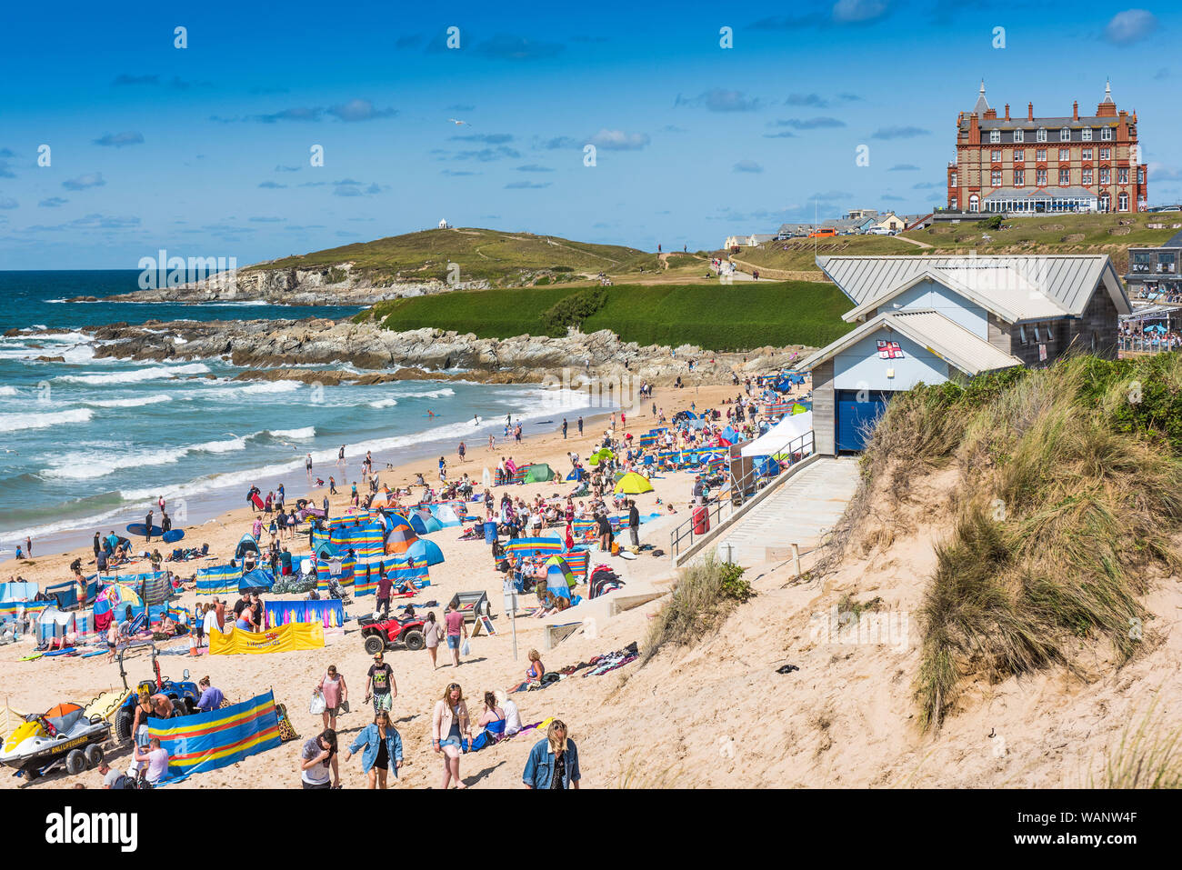 Holidaymakers on a staycation holiday on a sunny Fistral Beach in Newquay in Cornwall. Stock Photo