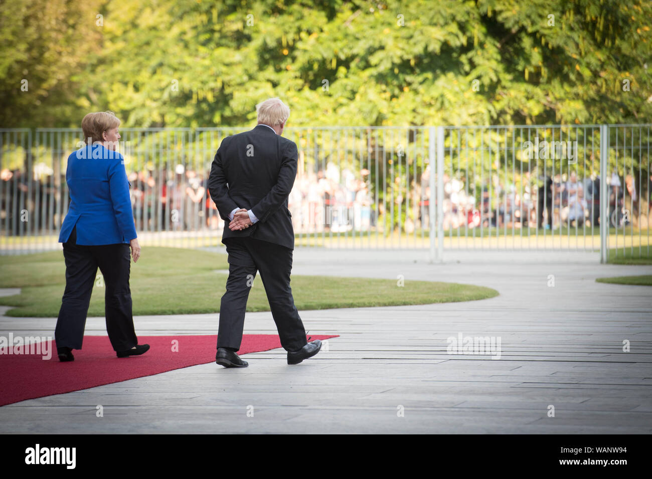 Prime Minister Boris Johnson walks with German Chancellor Angela Merkel in Berlin as he arrives ahead of talks to try to break the Brexit deadlock. Stock Photo