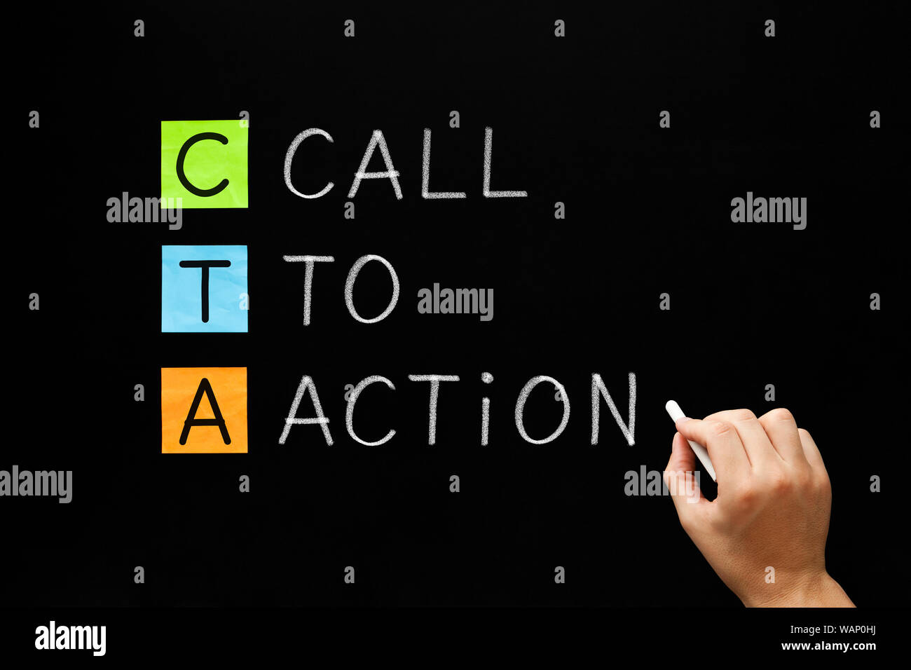 Hand writing business acronym CTA - Call To Action marketing concept with white chalk on blackboard. Stock Photo