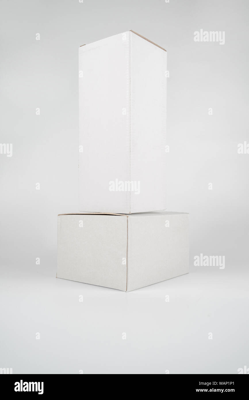 White two paper boxes - tall and fat lay on the white background in studio shot with clipping paht. Stock Photo
