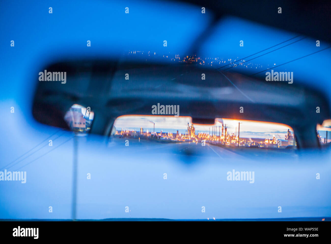 Photo taken through rear-view mirrow of Syncrude oil sands operations north of Fort McMurray, Alberta. Stock Photo