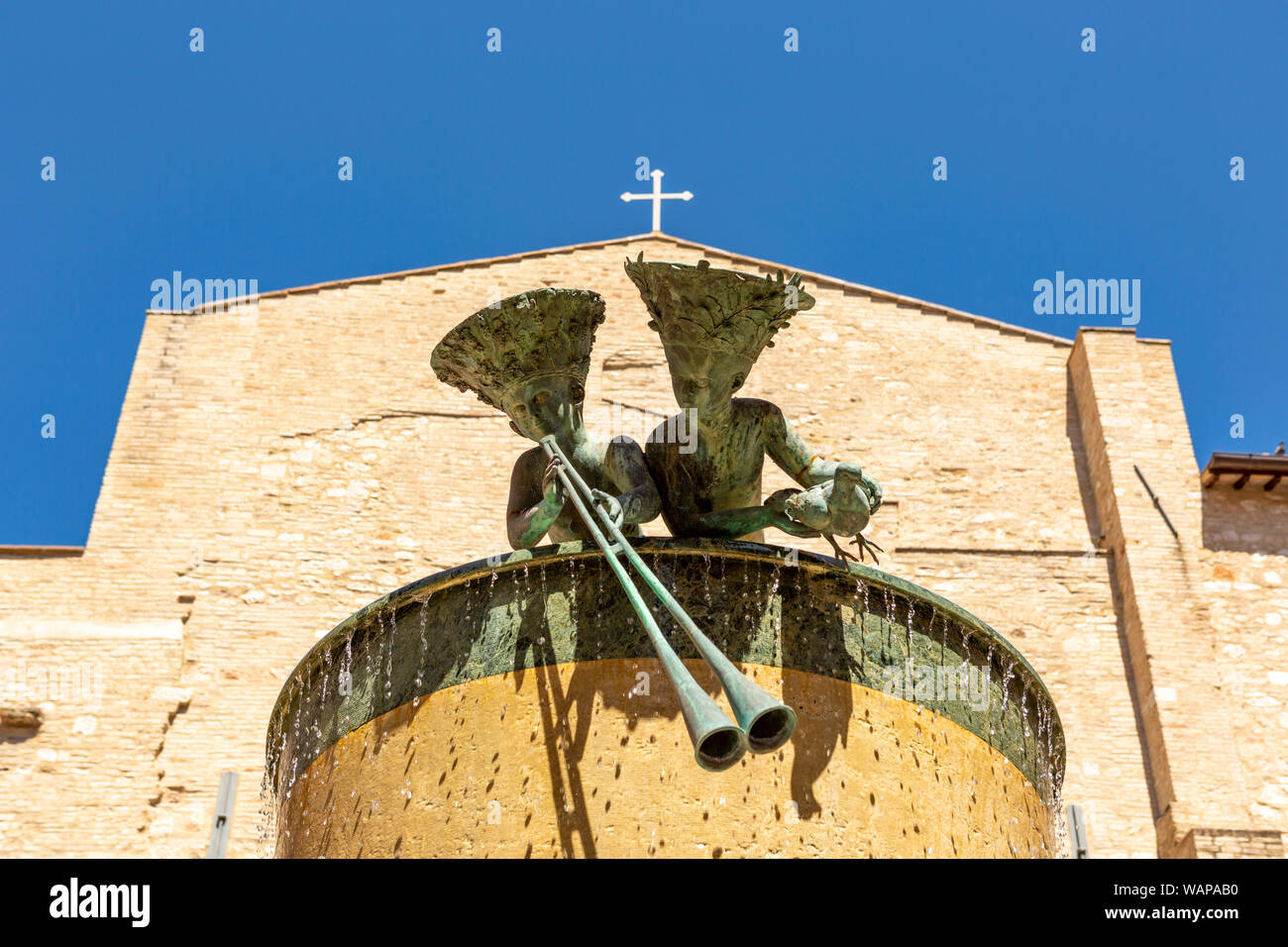 Ivan Theimer statue with two boys on top of a water fountain in the Italian city of Foligno. Stock Photo