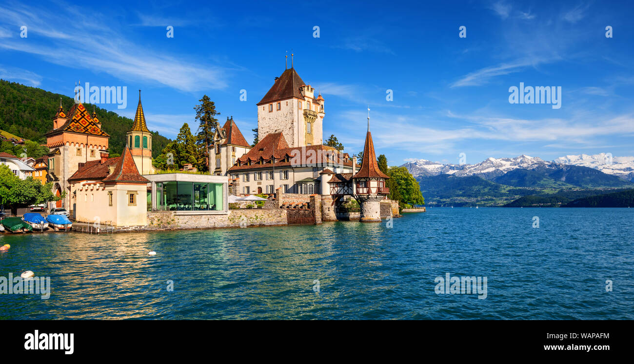 Oberhofen castle on Lake Thun in the Alps mountains, Canton Bern, Switzerland, panoramic view Stock Photo