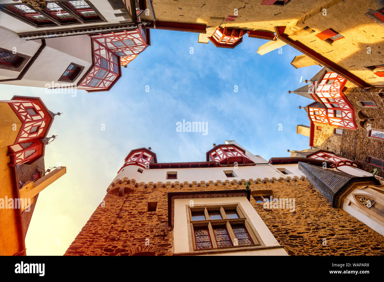 Burg Eltz, the famous medieval castle in Germany, low angle view from the courtyard up to the colorful half-timbered towers on sunset Stock Photo