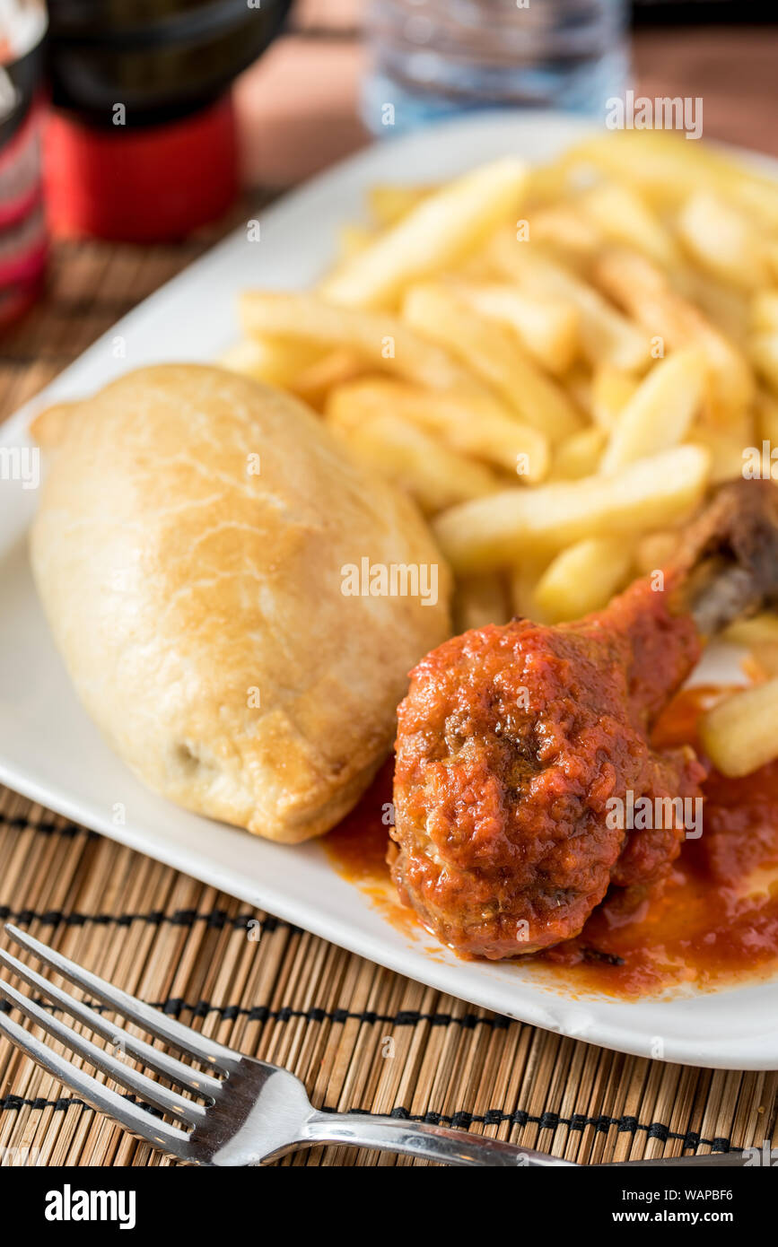Regional African Food on white plate on wooden background Stock Photo