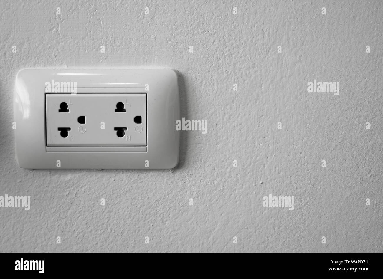 White universal electricity sockets plug on a white wall Stock Photo Alamy