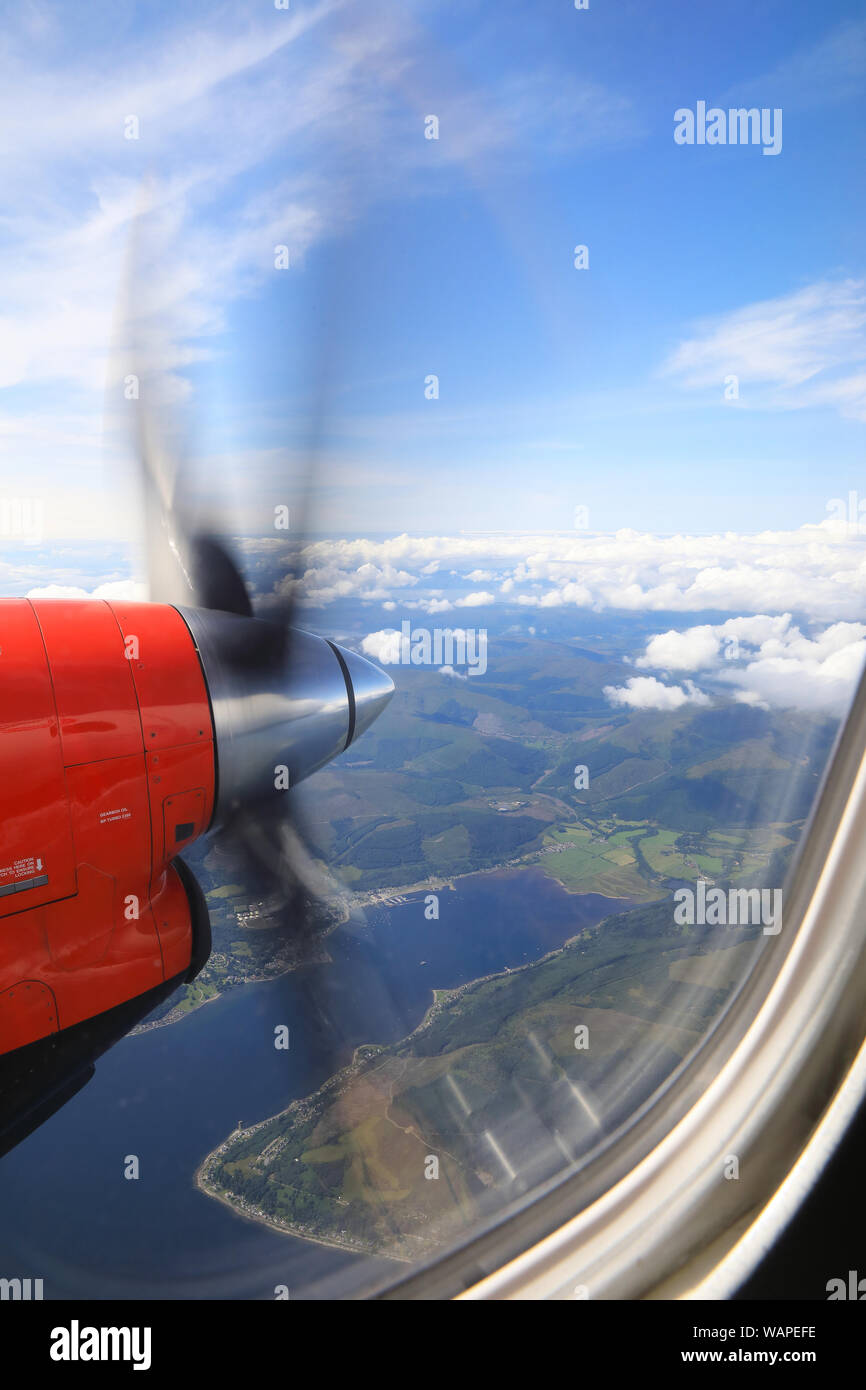 View from Loganair twin propeller plane flying up the west coast of Scotland, UK Stock Photo