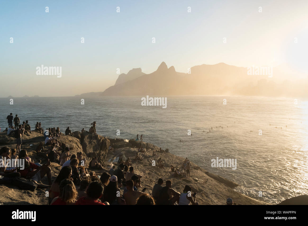 People watching the sunset from Arpoador Rock, Rio de Janeiro Stock Photo
