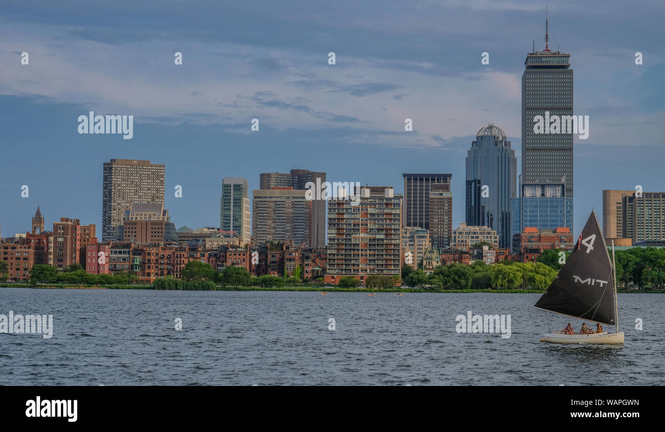 Charles river side in Boston, Massachusetts, USA - July 28, 2018: Sailboat traveling across Charles river with the skyline of the city in the backgrou Stock Photo