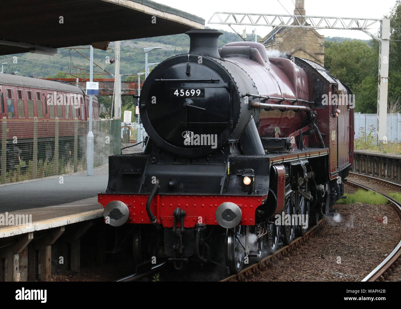 Preserved Stanier Jubilee class steam locomotive 45699 Galatea reversing through Carnforth station after arriving from York on 21st August 2019. Stock Photo