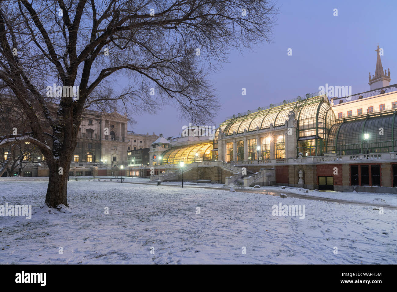 Palmenhaus greenhouse view from the Hofburg palace gardens covered with snow, Burggarten, Vienna, Austria Stock Photo