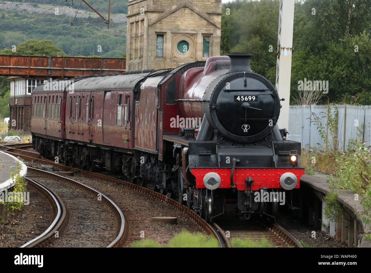 Preserved Stanier Jubilee class steam locomotive 45699 Galatea arriving at Carnforth railway station with ecs working from York on 21st August 2019. Stock Photo