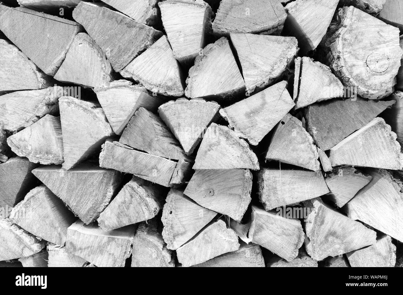 Background, texture of the wall from the folded logs. Black and white. High contrast. Stock Photo