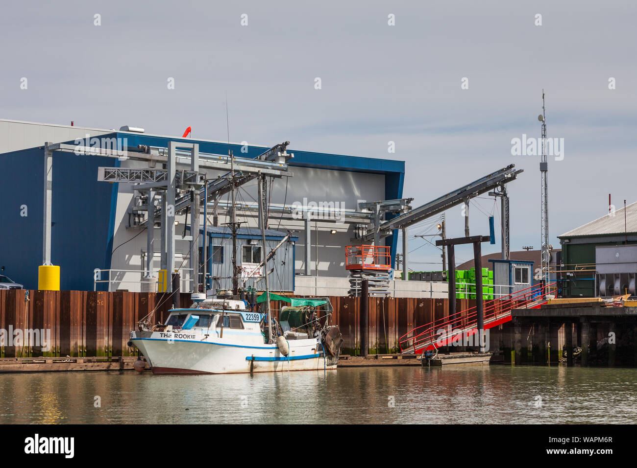 Small commercial fishing boat loading up with ice at Steveston before heading out to the fishing grounds Stock Photo