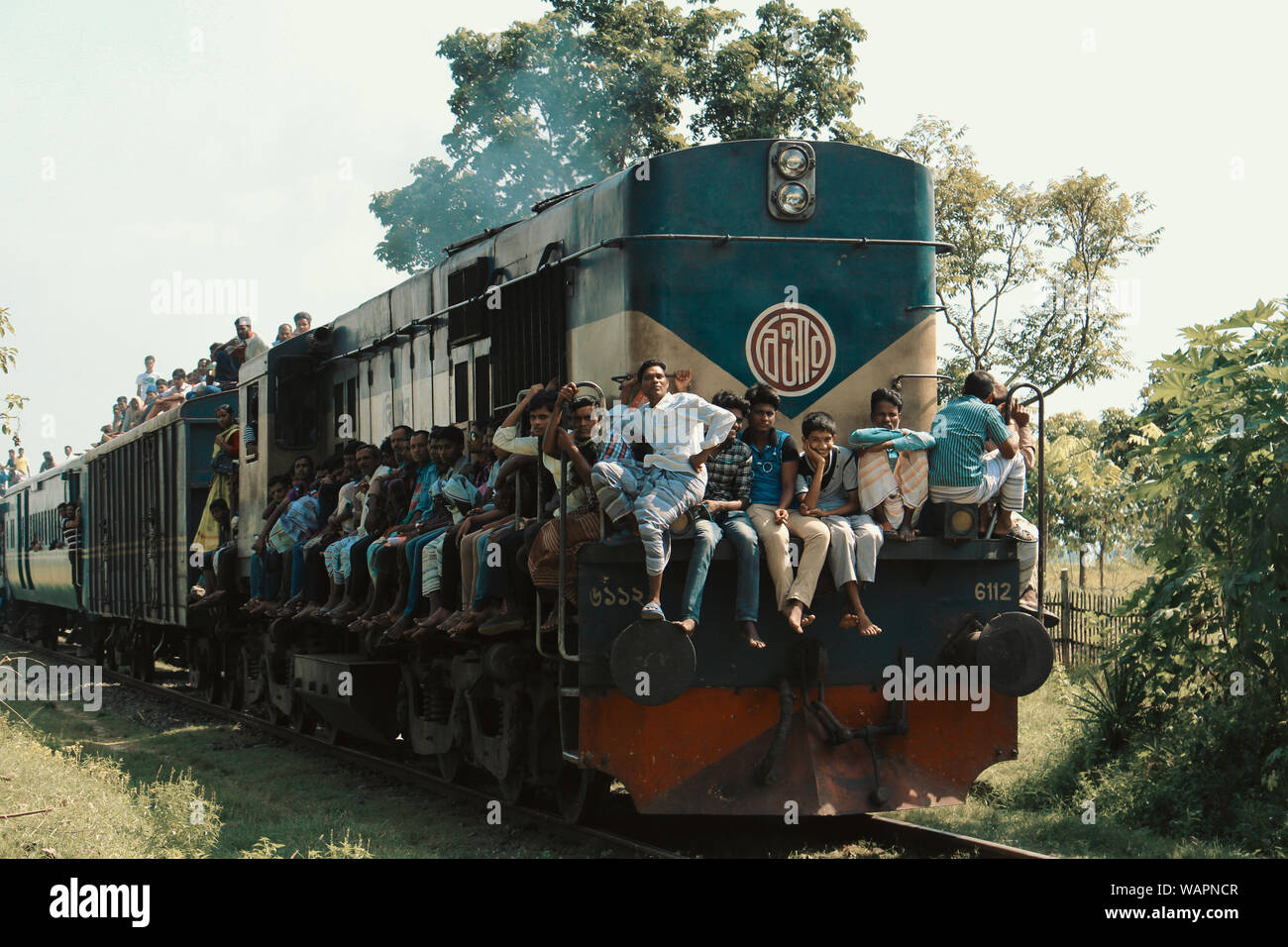 Chapai Nawabganj, Bangladesh, 2017. An over crowded train is passing by from an rural station to another. Stock Photo