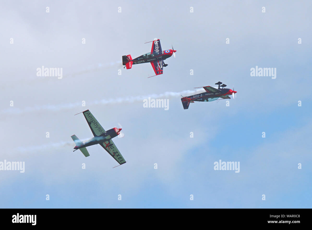Three of the Blades Aerobatics Team perform this amazing stunt for the crowds at Eastbourne's International Airshow in August 2019. Stock Photo