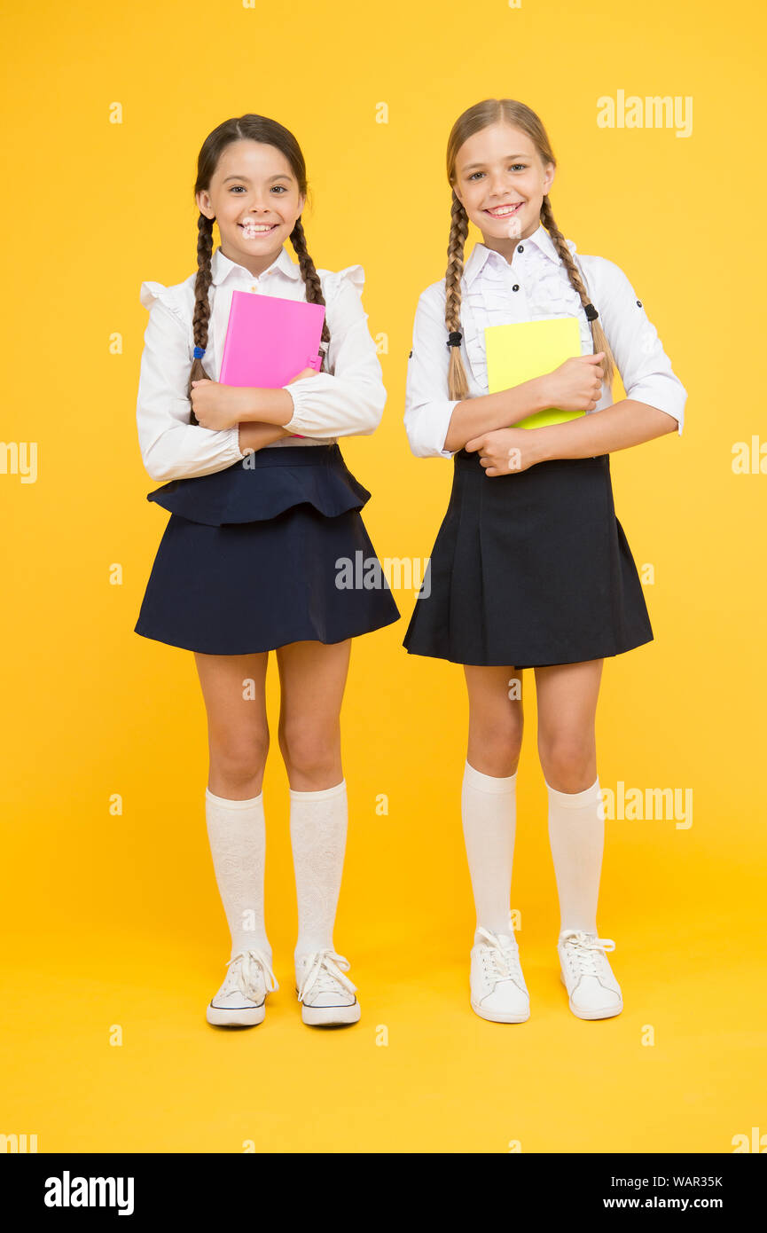 schoolgirls School friendship. Schoolgirls wear school uniform. Knowledge day. School  day. Girl with copy books or workbooks. Study together. Kids cute students.  Schoolgirls best friends excellent pupils Stock Photo - Alamy