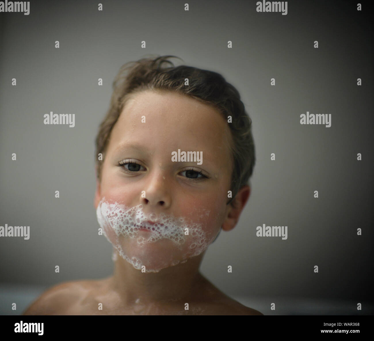 Boy with bubbles on face Stock Photo Alamy