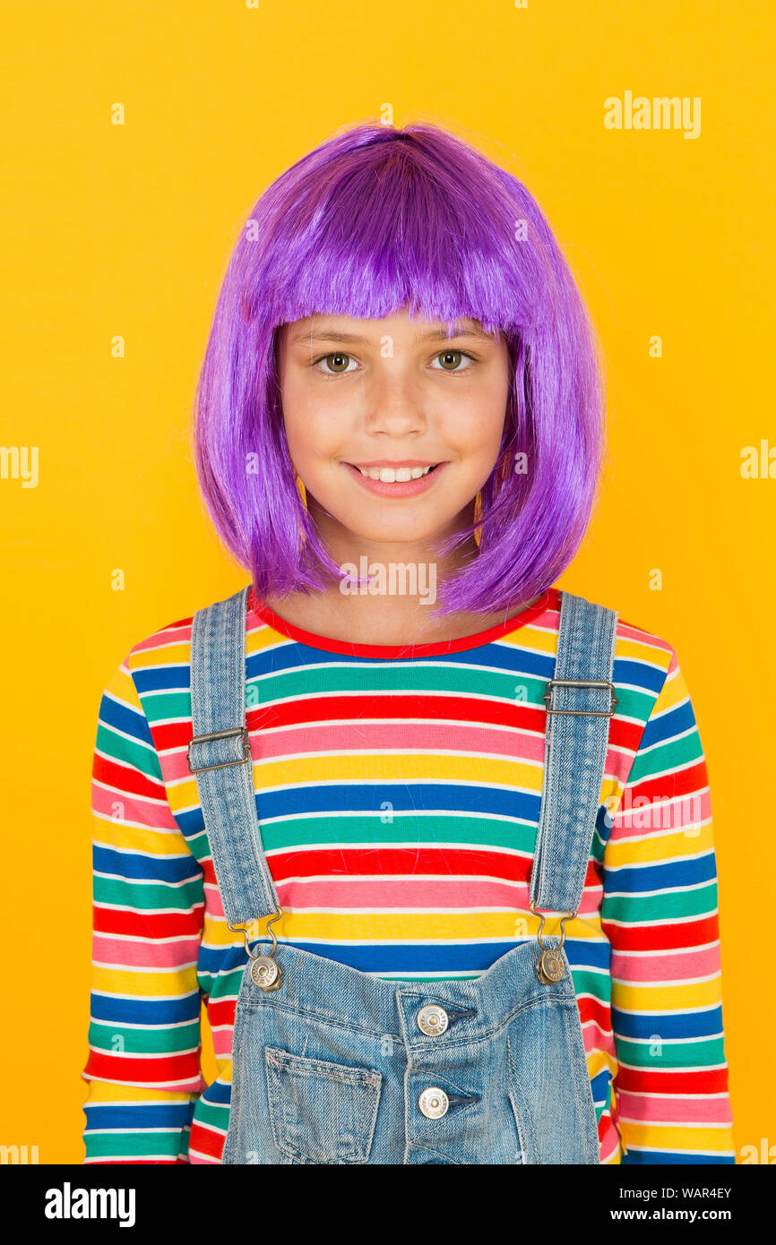 Anime fan. Cosplay kids party. Child cute cosplayer. Cosplay outfit. Otaku girl in wig smiling on yellow background. Cosplay character concept. Culture hobby and entertainment. Happy childhood. Stock Photo