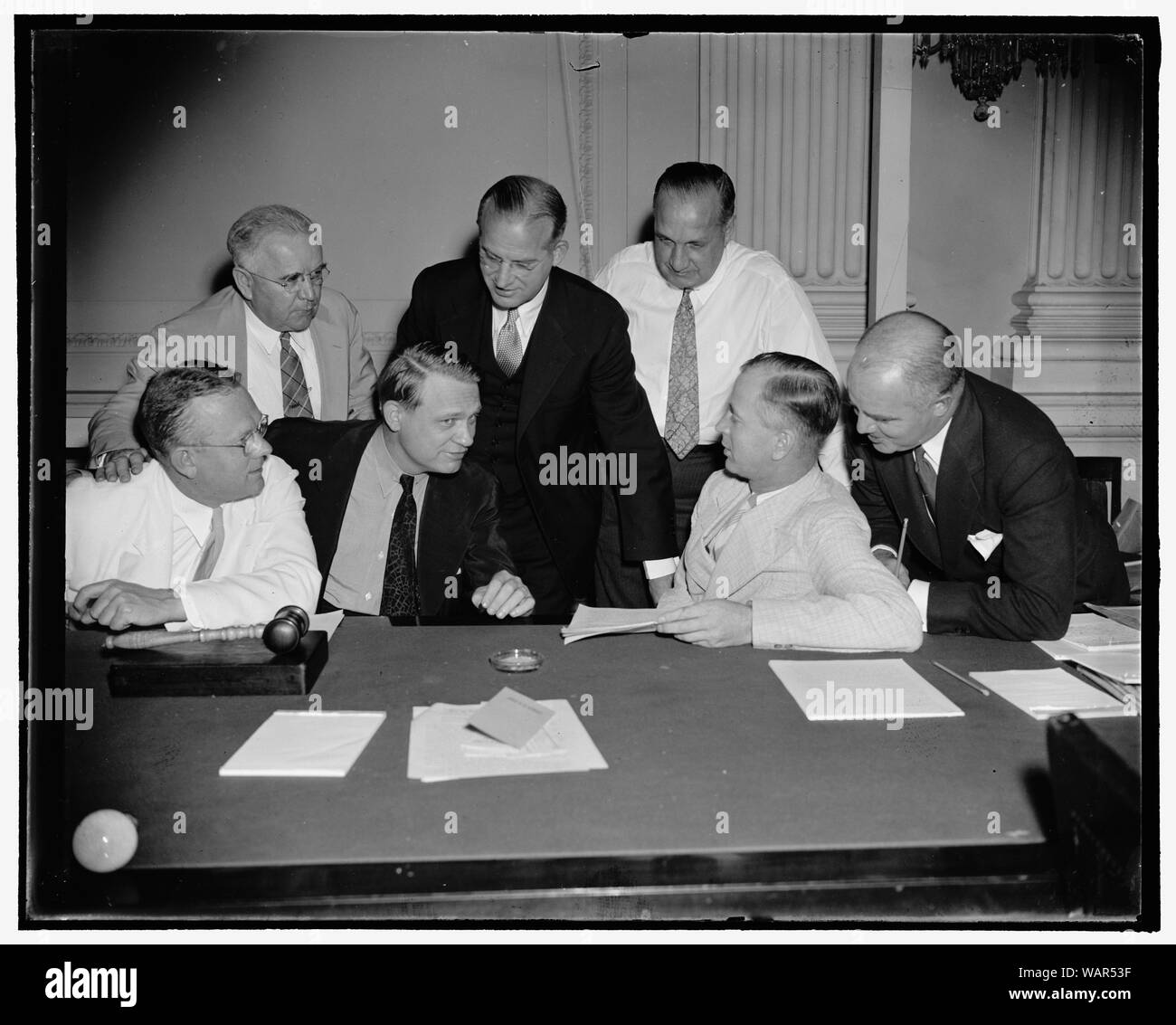 Dies Committee appoints subcommittee to hearings on Nazi activities. Washington, D.C., Aug. 22. Members of the House Committee investigating Un-American activities met today and decided to appoint a subcommittee to begin hearings on Nazi activities. Chairman Dies said the hearings would be held in another city, but declined to reveal its location. In the photograph, left to right: Rep. Harold G. Mosier, Rep. Noah M. Mason, Chairman Martin Dies, Dr. J.B. Matthews, former communist organizer, who testified today; Stephen Birmingham, investigator; Rep. Joe Starnes, and Rep. J. Parnell Thomas, 8/2 Stock Photo