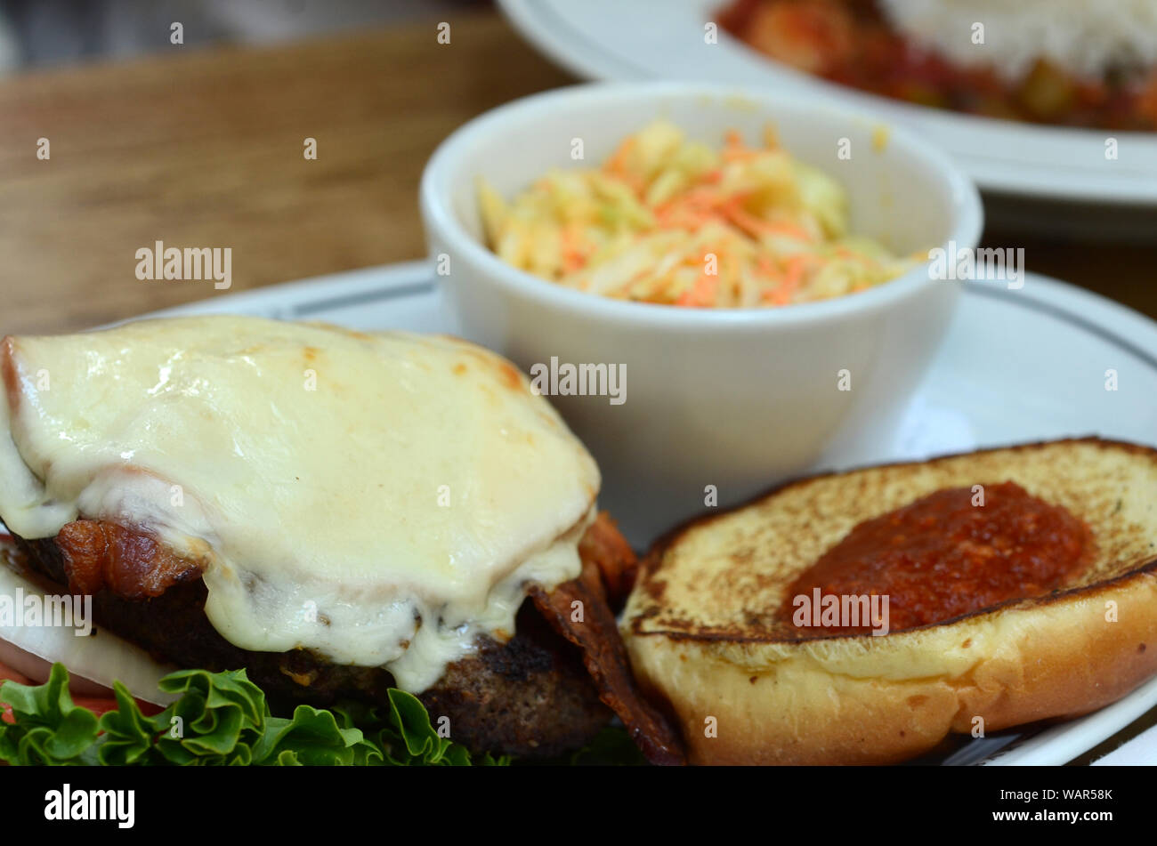 KING BEEF: A gourmet bacon cheeseburger with a rare horse radish spread is served up for a lunch meal at a restaurant in a Savannah, Georgia. Stock Photo