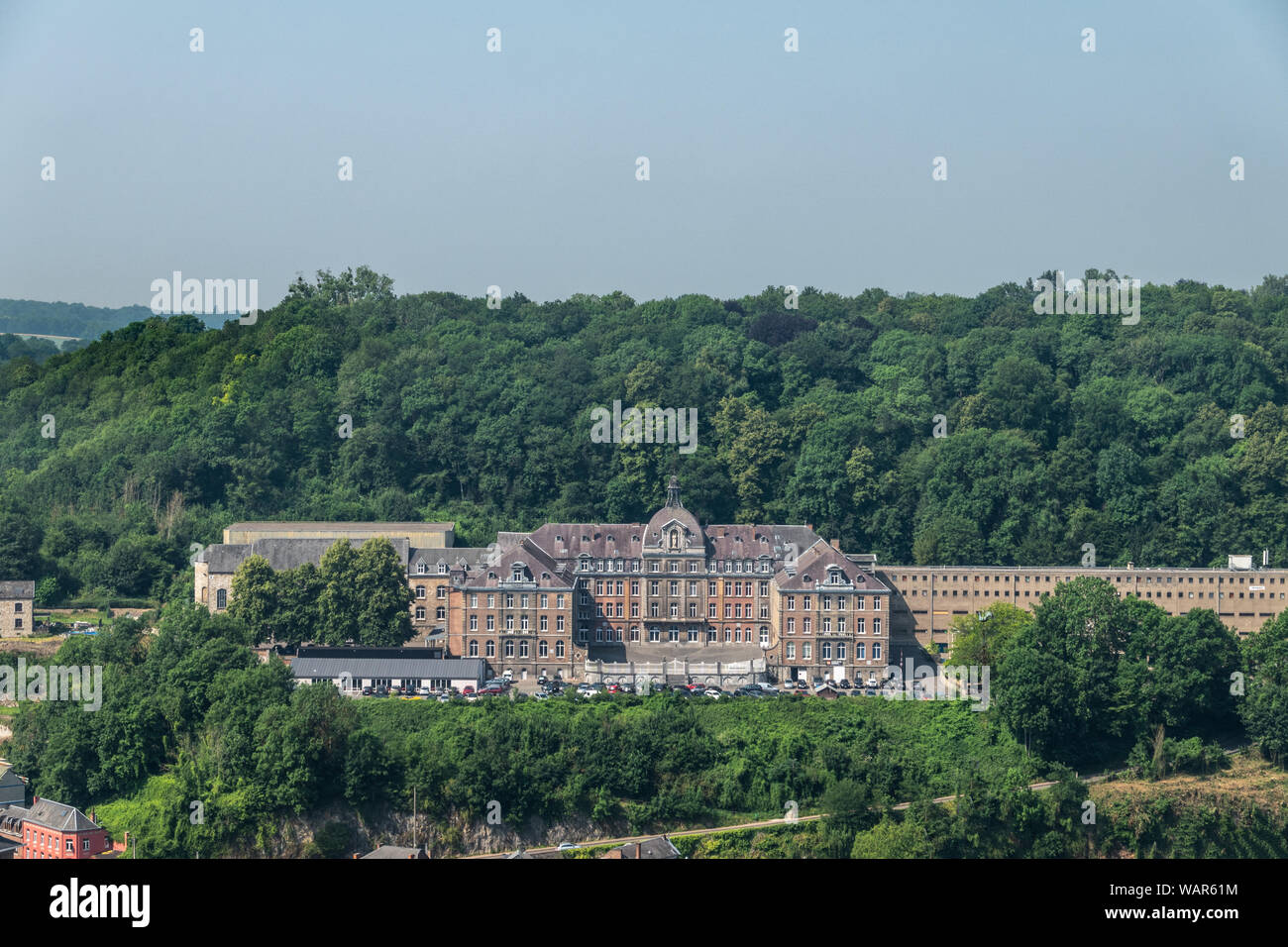 Dinant, Belgium - June 26, 2019: Seen from Citadelle. Large building is College Notre Dame de Bellevue, school system from primary to high school. For Stock Photo