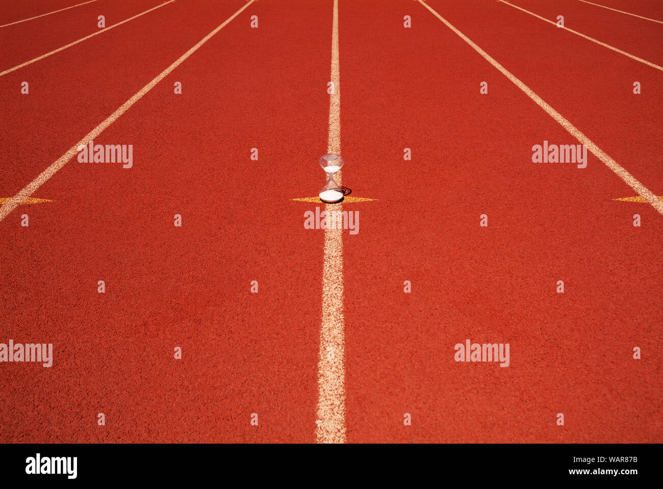 TIMELINE: An hourglass sits on a high school racetrack. Stock Photo