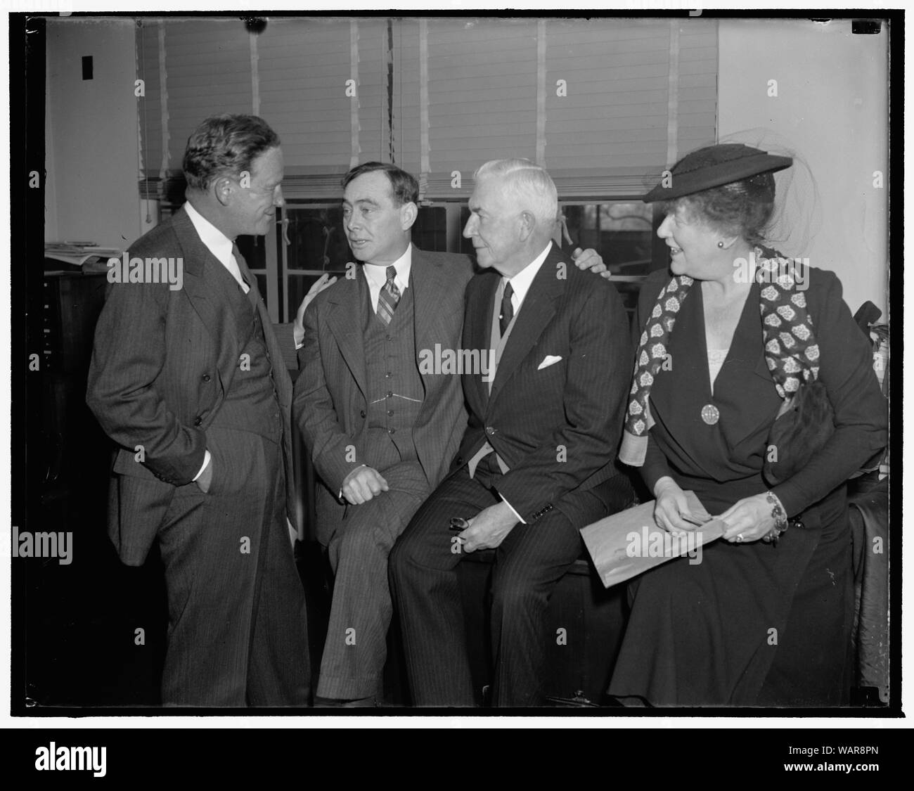 Discuss Repubican Party problems. Washington, D.C., Dec. 7. Snapped in a huddle just before the meeting of the Executive Committee of the Republican National Committee convened today were, left to right: John Hamilton, Chairman of the Republican National Committee; Rep. Joseph W. Martin Jr., House Republican Leader; Henry P. Fletcher, General Counsel; and Mrs. Paul Fitzsimons, member of the Executive Committee from Rhode Island. Presidential campaign problems and an embarrassing deficit were discussed at the meeting Stock Photo