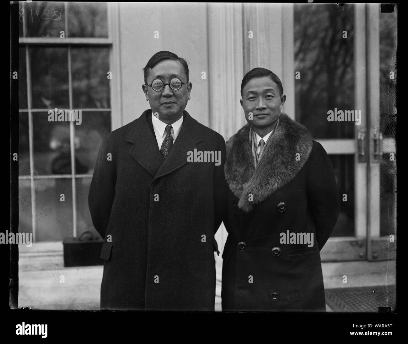 Distinguished Chinese visitor at White House. Dr. Y.C. James Yon, General Director of the Chinese National Mass Educational Movement, was presented to President Coolidge today by the Chinese Minister Sao-Ke Alfred Sze, on left in photograph. Dr. Yen is a graduate of Yale Stock Photo