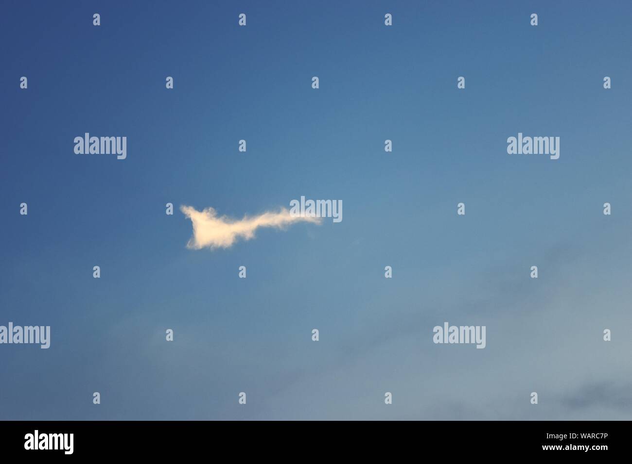 Cloud shaped check mark on blue sky , Fluffy clouds formations at tropical zone Stock Photo