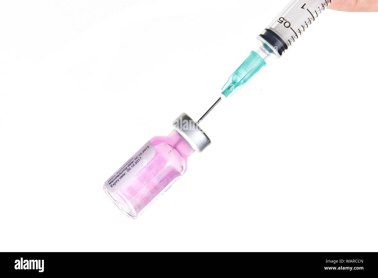 Insert syringe into a vial for pull the purple liquid into the cylinder, Rabies vaccination to