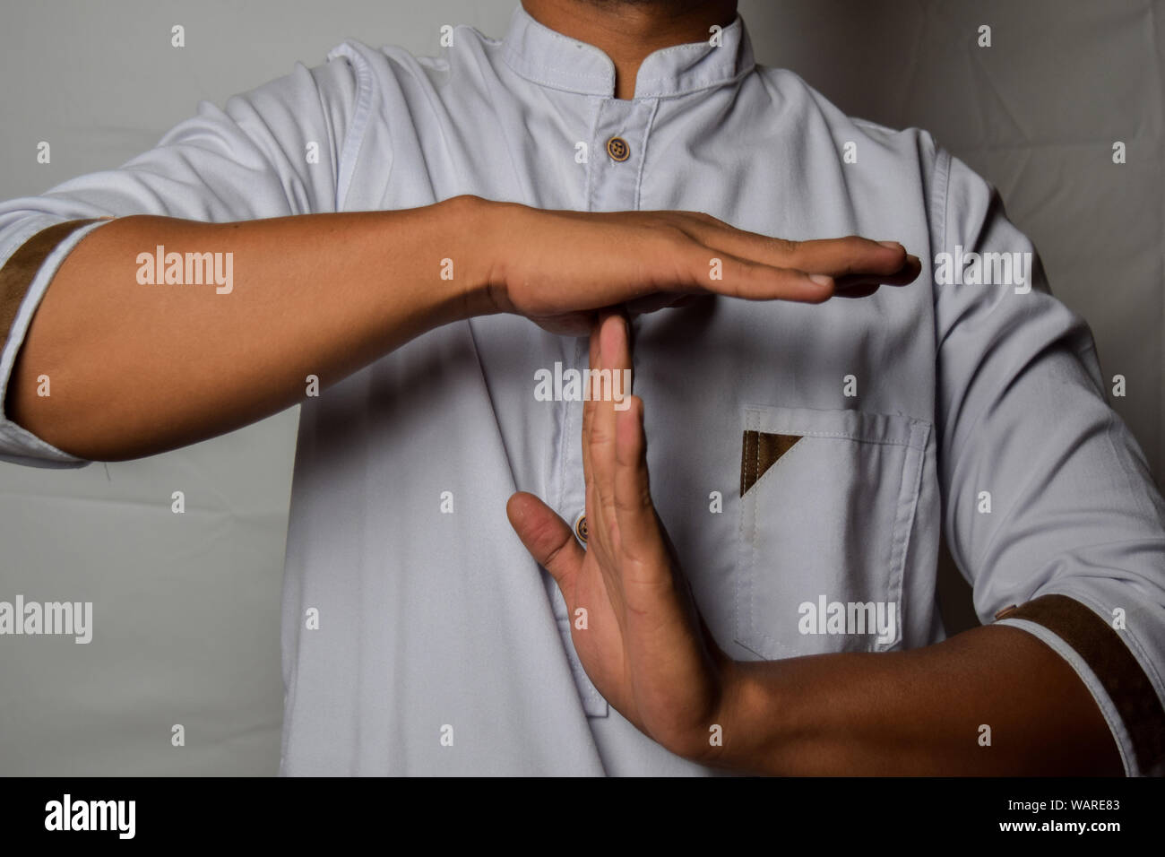 Close up Asian man shows hand gestures it means time out isolated on white background Stock Photo